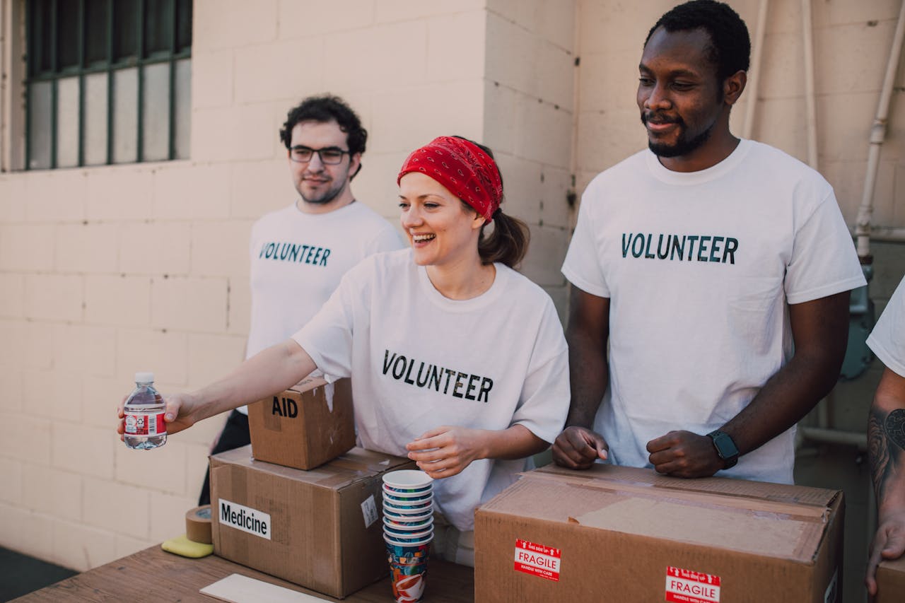 about-01 Volunteers distributing aid at an outdoor donation center, promoting social impact and diversity.